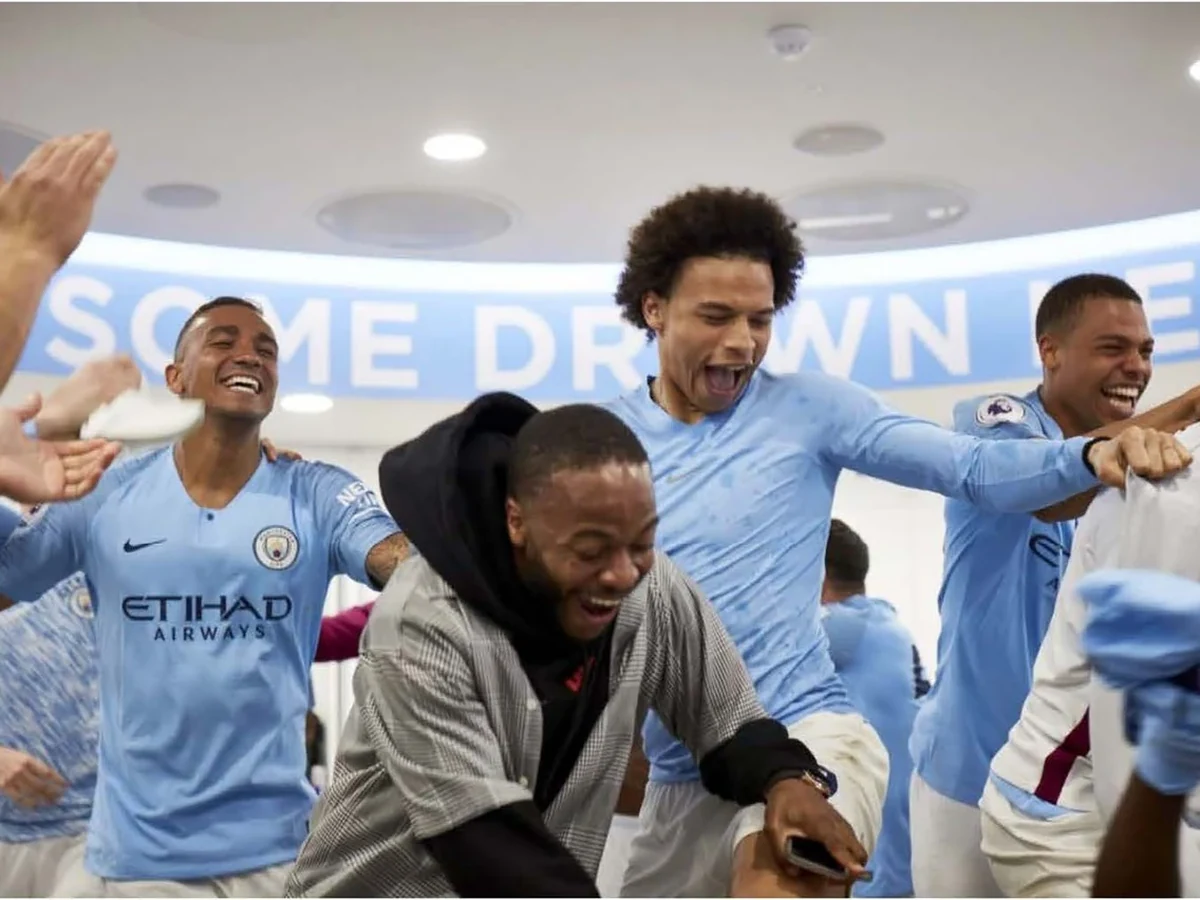 Manchester City players celebrating in the dressing room