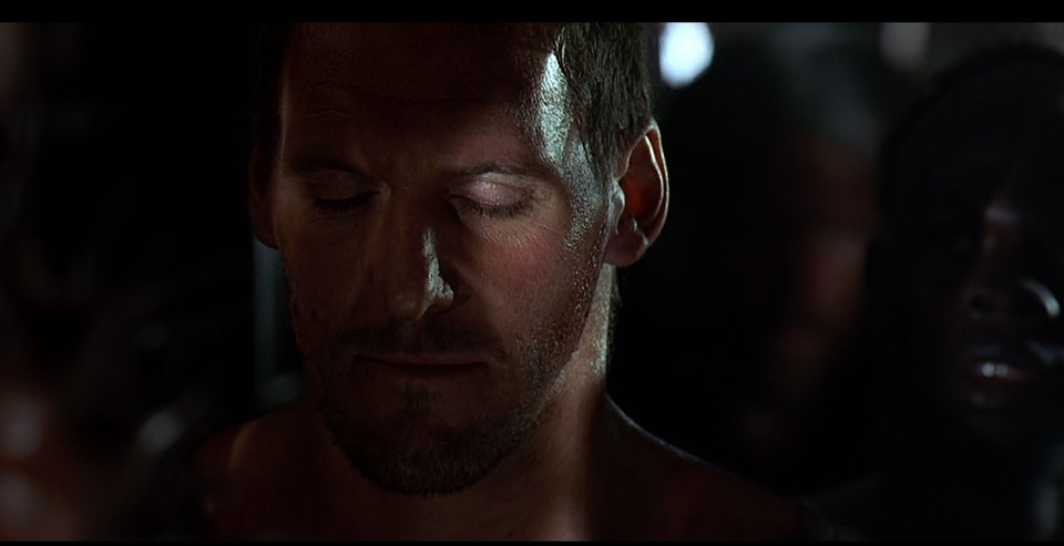 Low-key Gladiator reference close-up of Maximus with his eyes closed before the arena action.