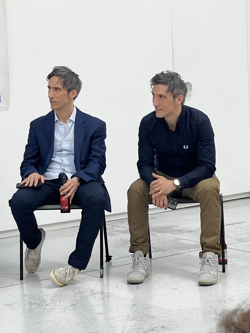 Luca and Gabriele Stifani seated together in a white studio